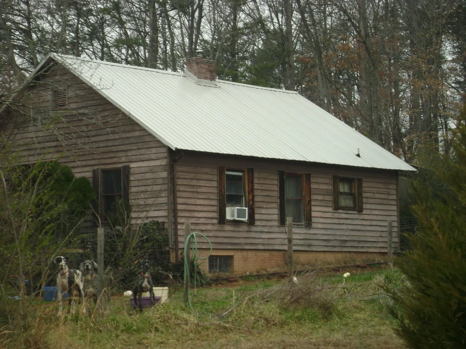White metal roof on an old wood sided farmhouse, from a Metal Roof Installation job in Tarrs